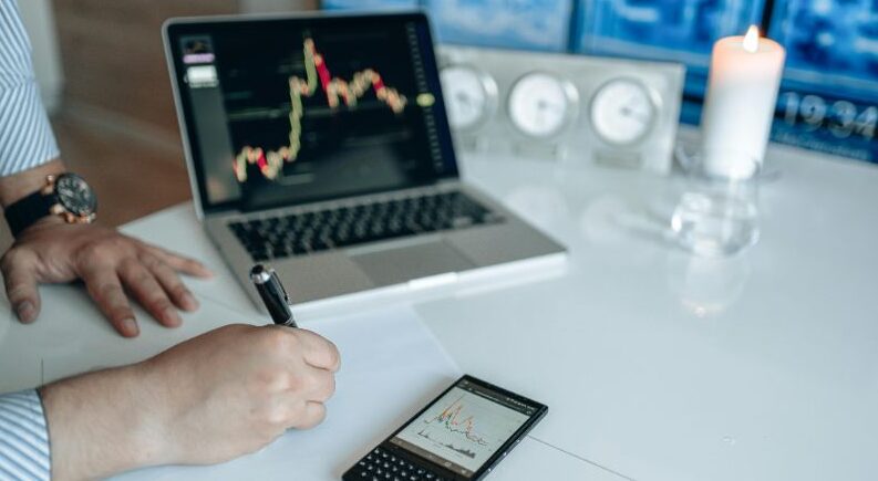 Person Writing on a White Paper